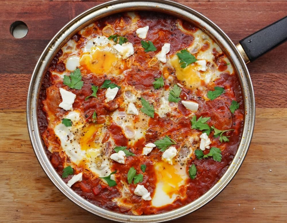 مقلاة فيها بندورة و بيض و بقدونس. شَكْشُوكَة